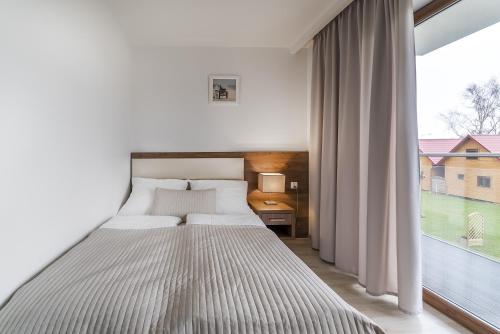 Postel nebo postele na pokoji v ubytování Apartamenty i Pokoje Gościnne Relax