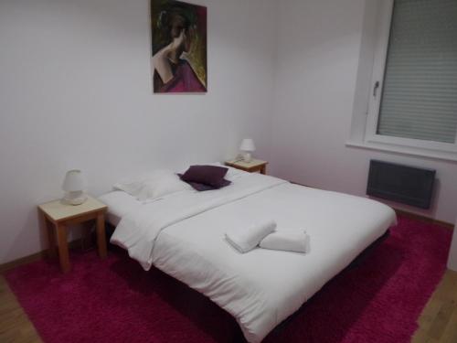 a bedroom with two beds and a painting on the wall at Domaine de Bel Air in Cérans-Foulletourte