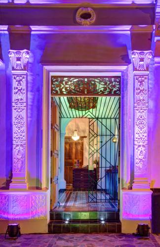 an entrance to a building with purple lighting at Casa de Leda, a Kali Hotel in Santa Marta