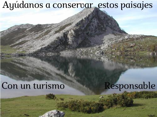 a mountain reflecting in a body of water at El Conventu del Asturcon in Lago