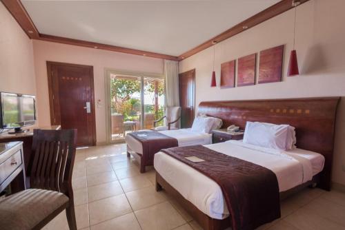 A bed or beds in a room at Shams Prestige Abu Soma (Adults Only)