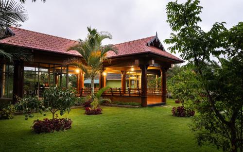 a house with a garden in front of it at Fun Retreat Resort, Hotel and Ayurveda Spa in Arusha