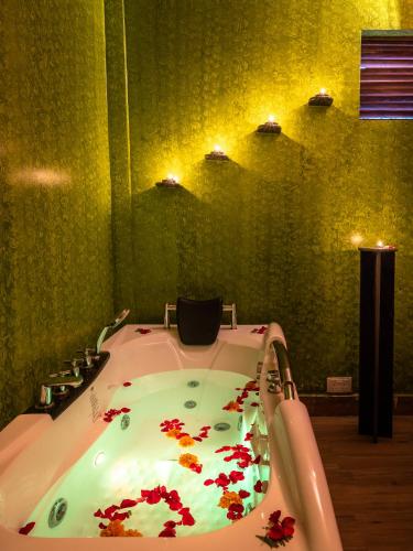 a bathroom with a bath tub with flowers on it at Fun Retreat Resort, Hotel and Ayurveda Spa in Arusha