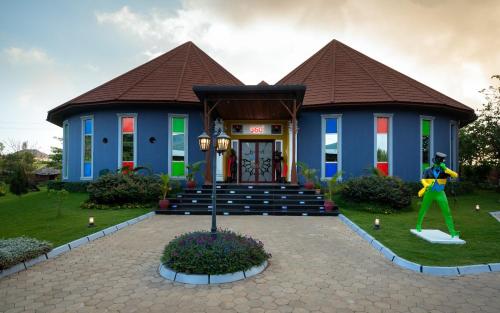 a house with a statue in front of it at Fun Retreat Resort, Hotel and Ayurveda Spa in Arusha