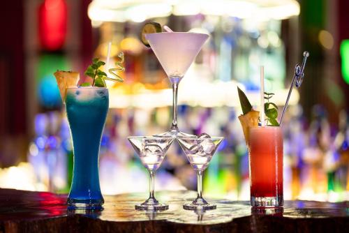 a group of four cocktails sitting on a bar at Fun Retreat Resort, Hotel and Ayurveda Spa in Arusha
