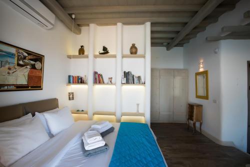 a bedroom with a bed with towels on it at Amallini Suites Mykonos in Super Paradise Beach
