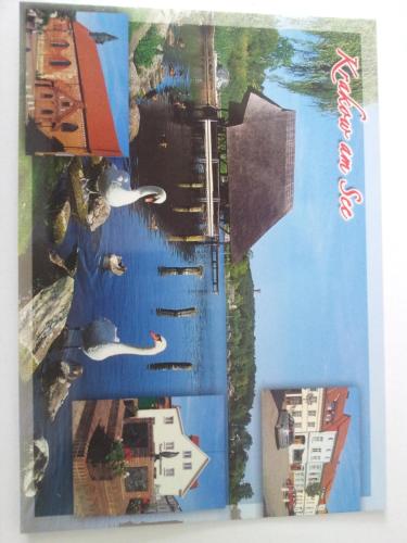 a book with a picture of a river and buildings at Haus der 16 Seen in Krakow am See
