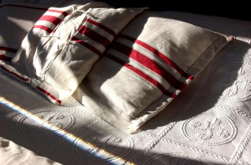 a close up of a pillow on a bed at Hotel Agur Deneri in Ciboure