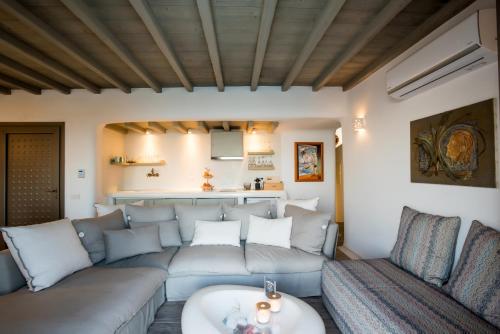a living room with a couch and a table at Amallini Suites Mykonos in Super Paradise Beach