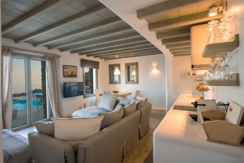 a living room with a couch and a table at Amallini Suites Mykonos in Super Paradise Beach