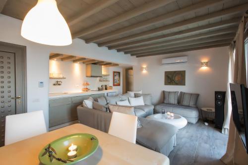 a living room with a couch and a table at Amallini Suites Mykonos in Super Paradise Beach