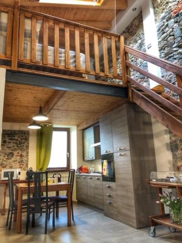 a kitchen with a dining table and a loft at PICCOLA VILLA nel Centro Storico in Arona