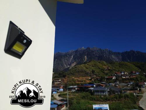 a view of a mountain range with a camera at Kupi-Kupi & Stay in Kundasang