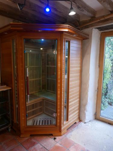 a wooden enclosure with a bird cage in a house at Les Insolites de Coco in La Lande-de-Goult
