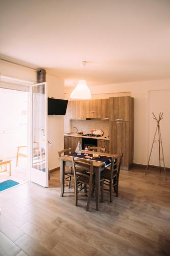 a kitchen and dining room with a table and chairs at The Lighthouse in Trappeto