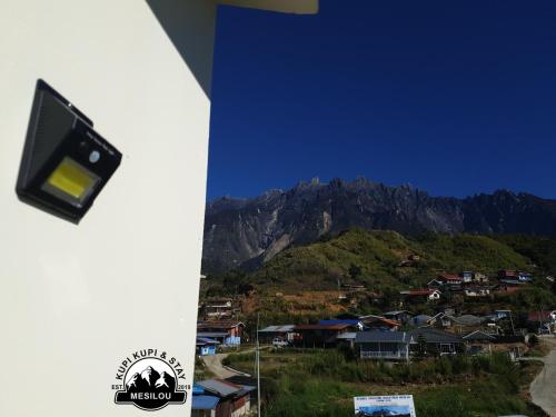 a view of a mountain with houses and a city at Kupi-Kupi & Stay in Kundasang