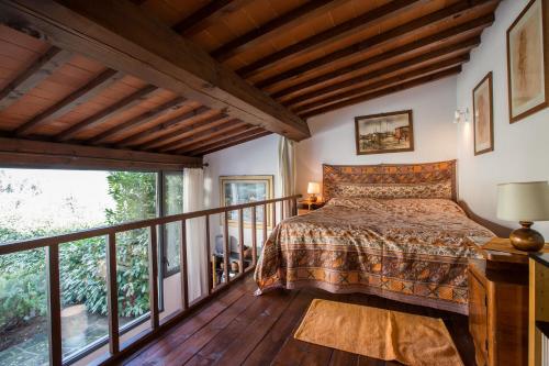 a bedroom with a bed and a balcony at Independent loft on Florence's hills in Fiesole
