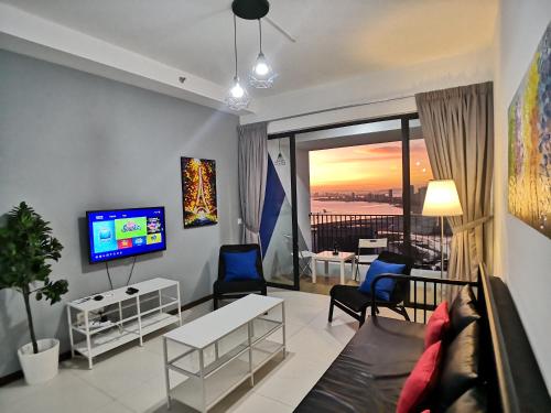 a living room with a couch and a tv at The Landmark Seaview Gurney in George Town
