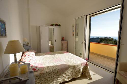 a bedroom with a bed and a sliding glass door at Casa Margherita in Imperia
