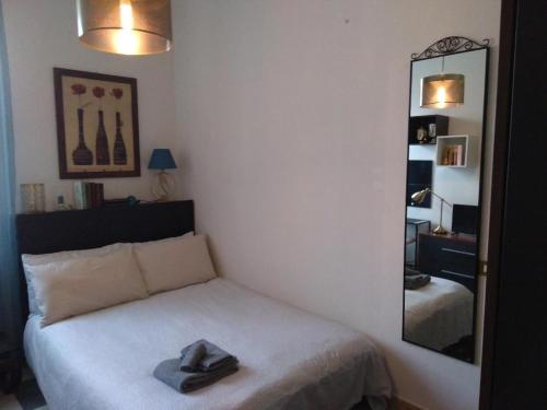 a bedroom with a bed with a hat on it at primopiano BnB in Bologna