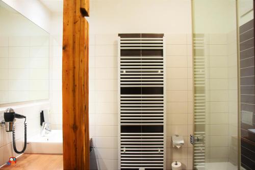a bathroom with a shower with black and white tiles at Hotel Brühlerhöhe in Erfurt