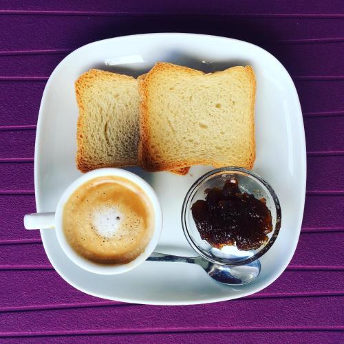 a plate with a cup of coffee and two slices of bread at Casa Canale in Reggio Calabria