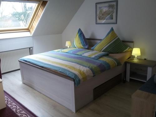 a bedroom with a bed in a room with a window at Pension Haus Erika in Cuxhaven