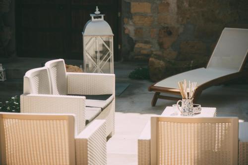 a group of chairs and a chair and a table at The Lighthouse in Trappeto