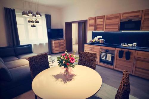 a kitchen and living room with a table and chairs at Bed&Bike Prachatice in Prachatice
