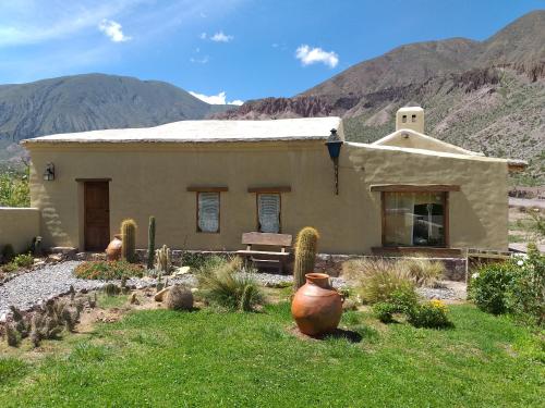 a small house in the middle of a mountain at Sendero De Las Cabras in Purmamarca