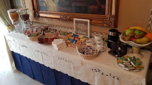 a table with baskets of fruit and other food on it at Luxury B&B IL Sogno in Cerignola
