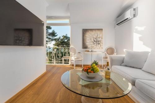 a living room with a couch and a glass table at Apartment Hannah in Novigrad Istria