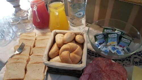 a table with a tray of bread and other foods at Luxury B&B IL Sogno in Cerignola