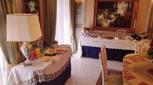 a dining room with a table with food on it at Luxury B&B IL Sogno in Cerignola