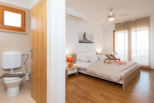 a bedroom with a bed and a toilet at Exceptional Beachfront Holiday Villa on Korčula Island in Prizba