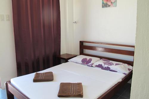 a bedroom with two beds with towels on them at Celtis Resort in Malapascua Island