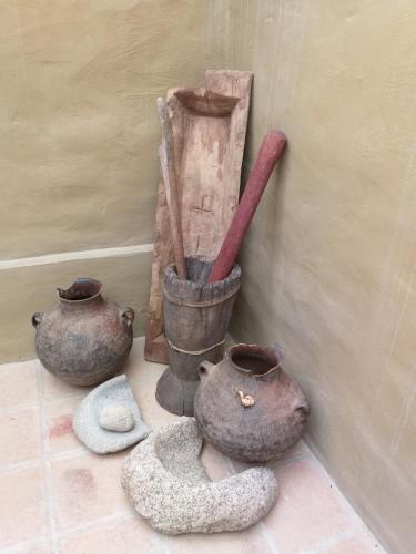a group of vases and utensils on a floor at Sendero De Las Cabras in Purmamarca