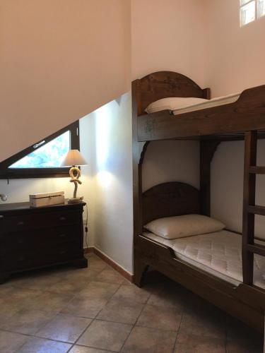 - une chambre avec des lits superposés, un bureau et une lampe dans l'établissement Appartamenti Sant'Andrea, à SantʼAndrea