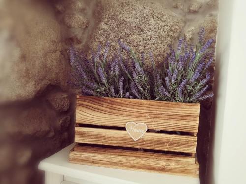 a wooden box with a heart on top of it at Isabel do Couto - casa de charme in Castro Daire