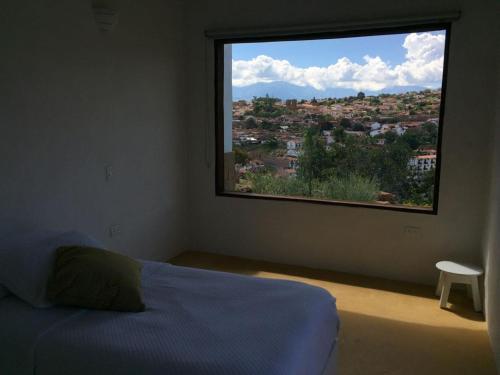 Villas La Antigua Barichara tesisinde bir odada yatak veya yataklar