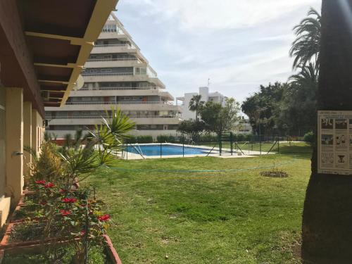 widok na budynek apartamentowy i basen w obiekcie Apartamento DELUXE Benalmádena w mieście Benalmádena