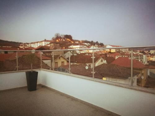 a balcony with a view of a city at Isabel do Couto - casa de charme in Castro Daire