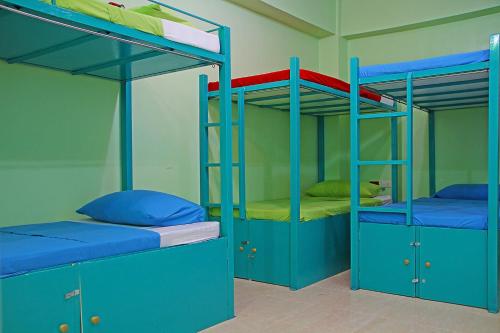 a room with two bunk beds with blue cabinets at Antwet Backpacker's Inn & Rooftop Bar in Dumaguete