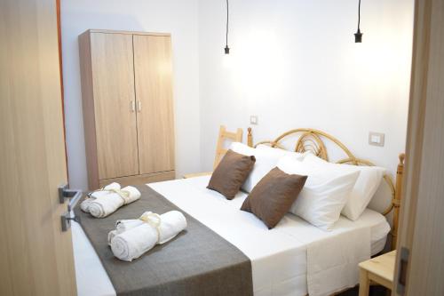 a bedroom with a large white bed with towels on it at Kitesurf lo Stagnone in Marsala