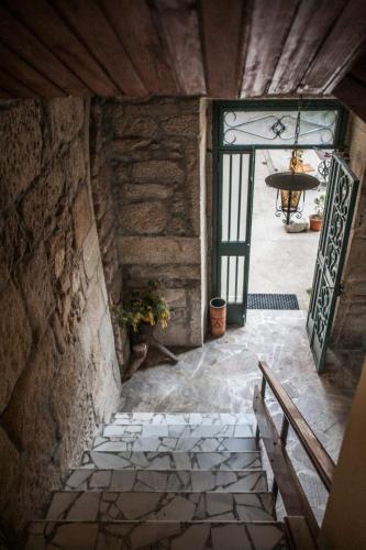 an entrance to a building with a door and a bench at Albergue Convento Del Camino in Tui