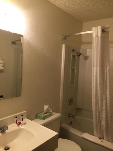 a bathroom with a sink and a toilet and a shower at Super 8 by Wyndham Raton in Raton