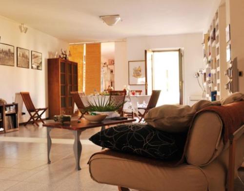 a living room with a couch and a table at Lanita B&B in Càbras