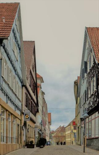 a city street with many buildings in a town at Hotel Krone Zentrum in Vaihingen an der Enz