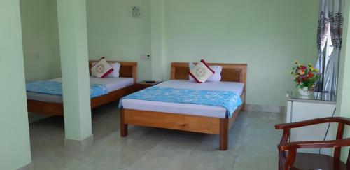 Säng eller sängar i ett rum på Hai Dang Hotel