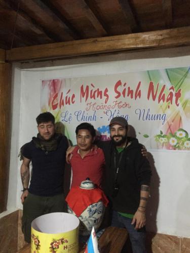 a group of three men standing in front of a sign at Nobita Homestay bắc hà in Bắc Hà